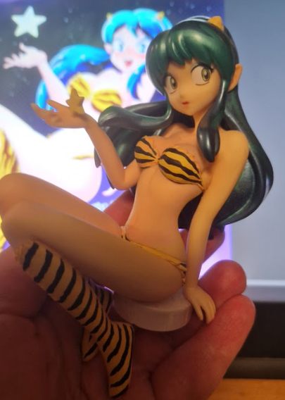 A plastic figurine of Lum from Urusei Yatsura. She's everyone's favorite oni alien, wearing a tiger striped yellow bikini.
I bought this one in Den Den Town in Osaka in 2018.