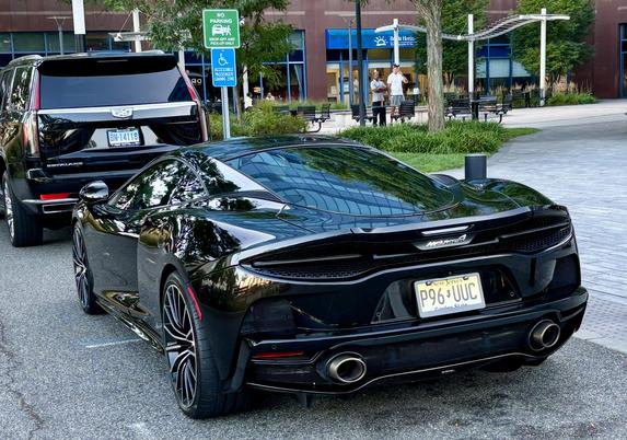 A black McLaren, rear view.