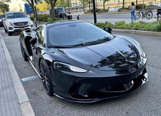 A black McLaren, front view.