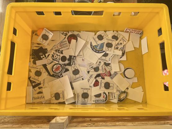 A yellow box full of mostly the same stickers.
