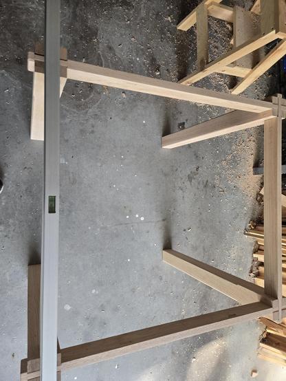 table dry fitted with a level across the right side legs showing it is level.