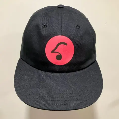 A black Mirlo cap with a red logo on it.