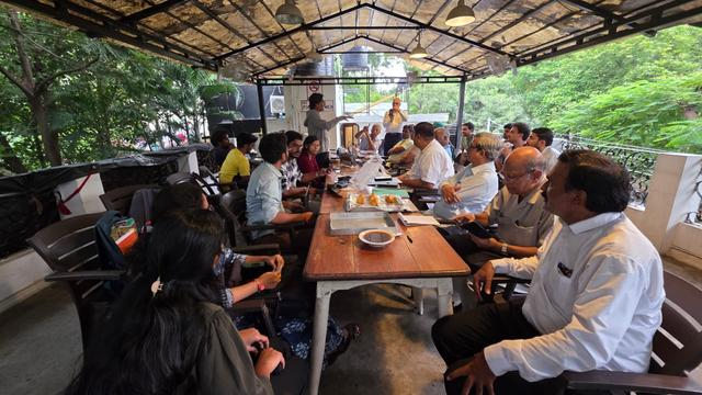 Group of people sitting around a talk and talking