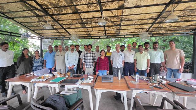 Group photo with people standing behind the table