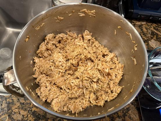 Shredded chicken breast fresh from the stand mixer bowl.