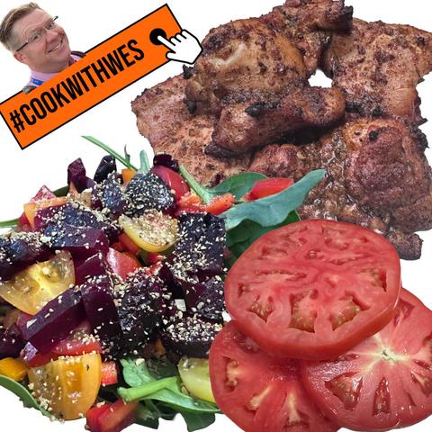 A colorful plate featuring seasoned grilled chicken, a vibrant salad with beets, tomatoes, and mixed vegetables, and sliced tomatoes. A graphic overlay displays the text “#COOKWITHWES” alongside a pointing hand.