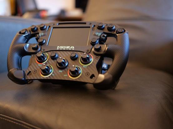 A Moza FSR2 Formula Wheel sitting on a chair.