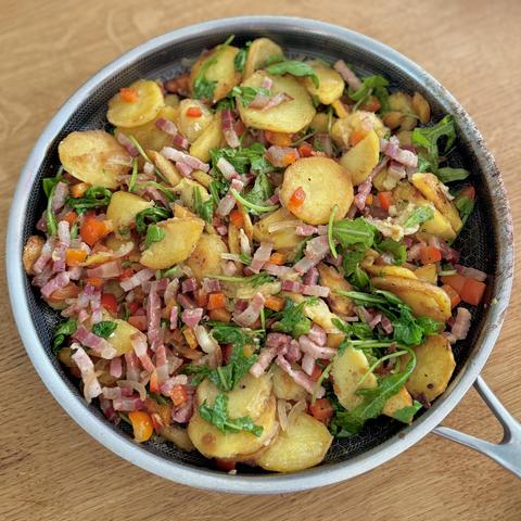 The fried potatoes in the frying pan, ready to be eaten.