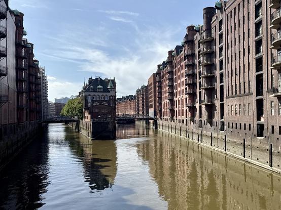 Dark red brick buildings at a canal at the Speicherstadt.