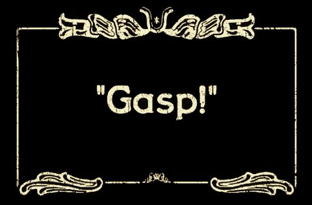 A dialog card of the style used in silent films. An ornate frame surrounds text that reads simply: "Gasp!"