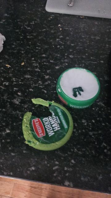 A tub of working hands hand cream. The lid is chewed up. At least she didn't eat the cream.