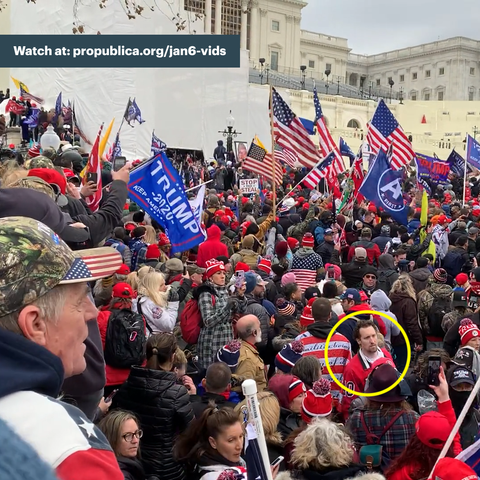 Screenshot of E.J. Antoni, a man with short brown hair wearing a red shirt, moving in the through a crowd of Jan. 6 rioters on Capitol grounds. He is highlighted with a yellow circle in the bottom right corner of the image.