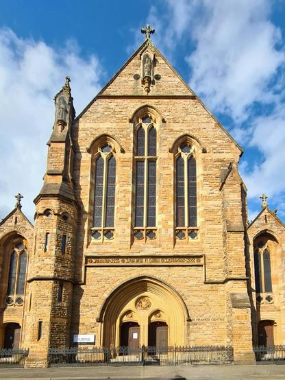 A large blonde sandstone Gothic style Victorian church