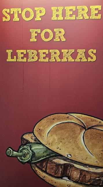 Plakatständer "Stop here for Leberkas"