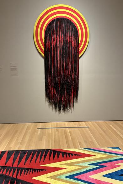 Fabric exhibit with bright red and yellow fibers