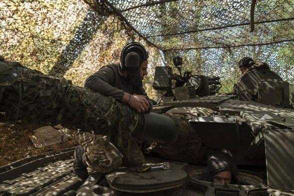 A group of Ukrainian military engineers and army tankmen prepare and maintain a T80 tank, captured in the fighting between Ukraine and Russia, by placing it in a new position near Kostiantynivka, Donetsk Oblast, Ukraine, in April 2025