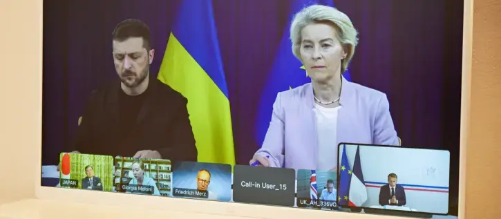 close-up on the video conferencing monitor with president selensky and Van der Leyen on screen in large and several other heads of states in the bottom area of the screen in small