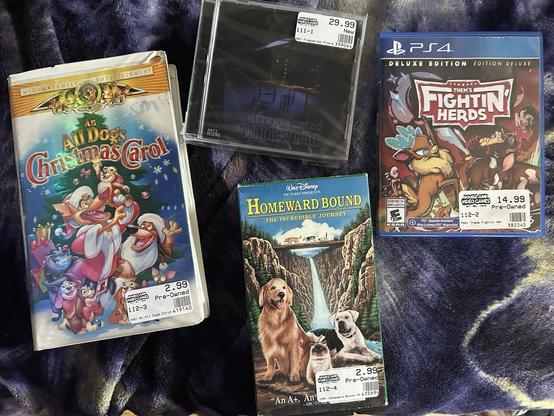 Left to right:
VHS - All Dogs Christmas Carol
VHS - Homeward Bound
Upper Game - Dreamcast Fragmented Almanac (Homebrew)
Right Game - Them’s Fightin’ Herds PS4
