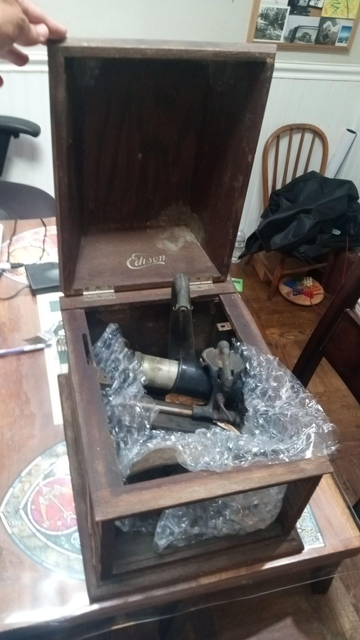 dilapidated wooden case full of mechanical parts