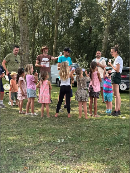 Kids and their parents after the food forest work