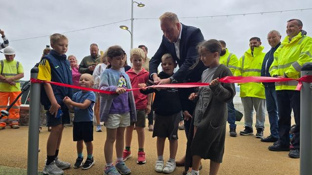 The new Mumbles seafront play area being opened by local children and council leader, Rob Stewart