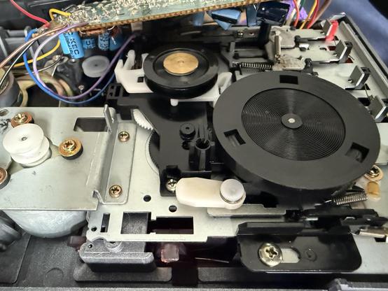 The inside of a 40-year old tape recorder. It’s all mechanical parts, wheels, spindles and old circuitry