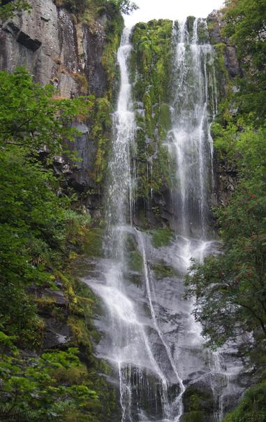 A waterfall. two ribbons of white water cascade over a narrow precipice.