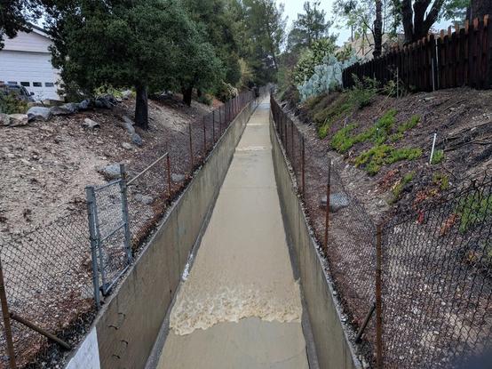 A series of roll waves propagating downstream.