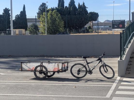 old mtb with a large trailer in a supermarket car space