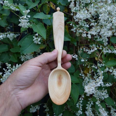 Wooden spoon held in vertical position