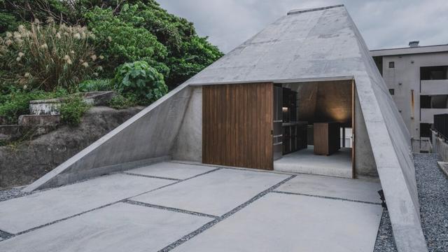 IGArchitects adds pyramidal concrete home to sloping site in Okinawa