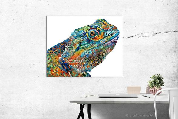 Colorful bearded dragon collage art by artist Sharon Cummings. In an office setting with a desk.