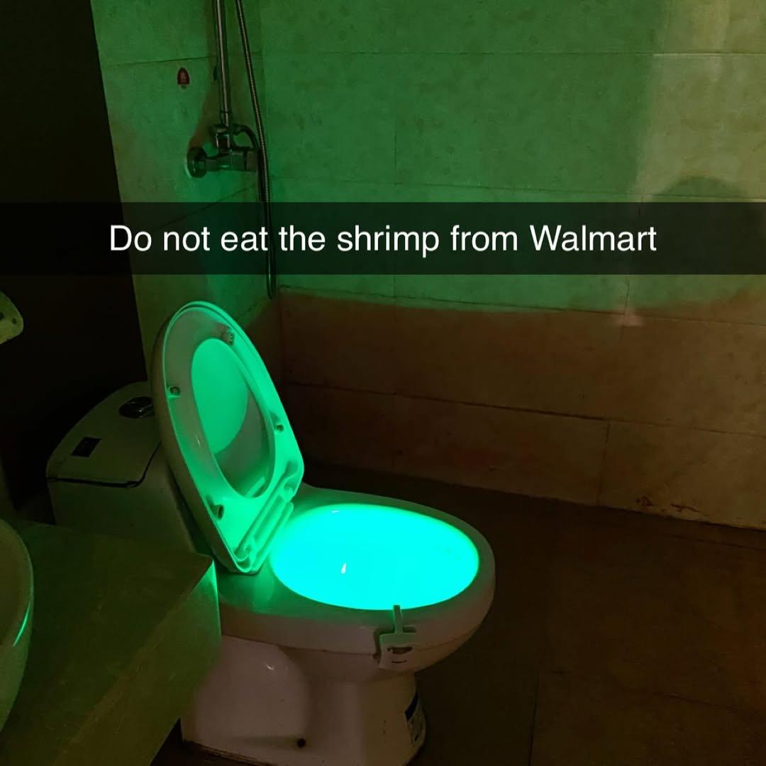 A picture of a toilet with an eerie green glow in the bowl, and the caption Do not eat the Shrimp from Walmart.