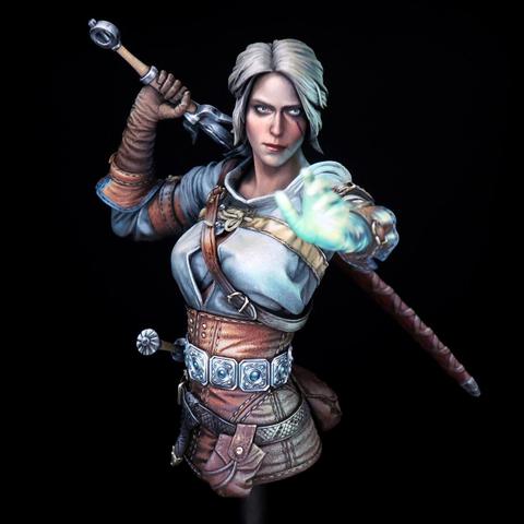 This striking image captures a masterfully painted miniature figure of Ciri from The Witcher series. Ciri’s expression is the first thing that grips you — her icy blue eyes pierce forward with unwavering focus, underscored by a faint scowl that suggests both inner strength and defiance. Her platinum-blonde hair, swept back in loose strands, frames her angular face with a touch of elegance, contrasting her rugged attire. Her right hand is flung forward, fingers splayed in a gesture mid-spell or telekinetic push, painted with an eerie greenish-blue glow that suggests magical power coursing through her veins — a stunning use of color that creates an otherworldly luminescence