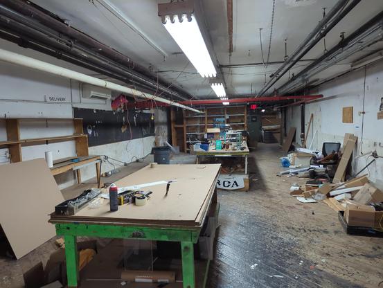 The basement of the old Tribeca space- complete with uneven floorboards ccovered in blockout paint drips and industrial stuff strewn about. I am sure the new tenants will probably rip all of this out.