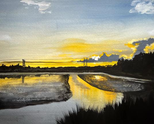 A marshland at sunset with tall grasses in shadow along the foreground. Pools of water reflect glowing streaks of yellow and gold, broken by dark patches of reeds. On the horizon, power lines and towers cut across a band of radiant sky where gray-blue tones fade into warm orange clouds.