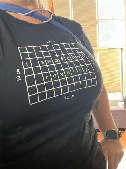 The front of my t-shirt, showing a printed 10x10 grid inside of which the text “I swatched Ravelry” is arrayed.

This is a a close to NSFW/tits on the internet as happens here.