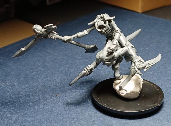 A robotic Necron with a scythe is riding an alien tyranid beast.