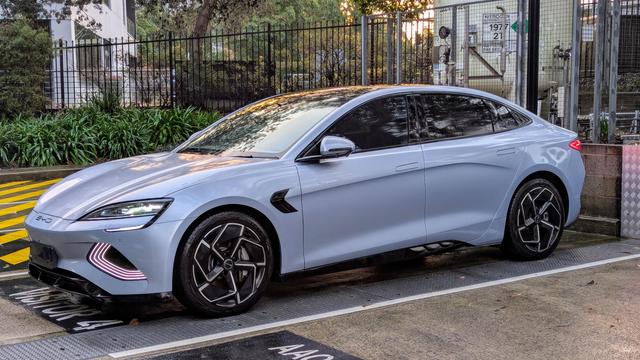 Photo of an 'Arctic Blue" BYD Seal electric sedan car, parked outside in evening light.