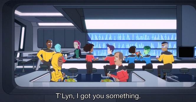 A scene from an animated series set in a futuristic bar or café, featuring diverse characters in colorful uniforms. Two of the characters are seated in the foreground, while the rest of characters are at the background at a bar.