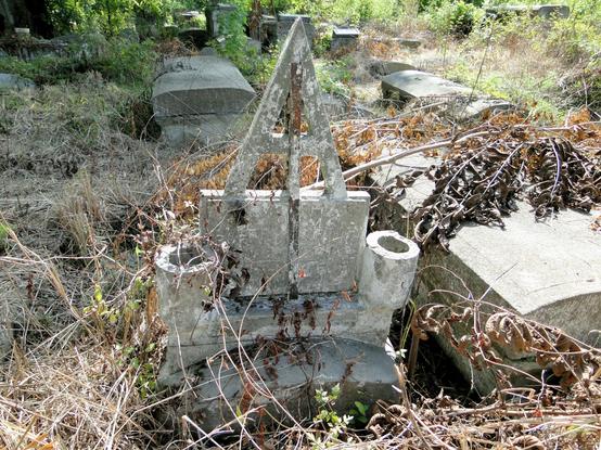 Mr. "A"''s grave.  Lot of handmade concrete memorials.  Most graves unmarked.