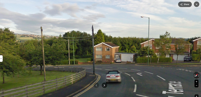 2009 Google Street View image of Sunny Terrace, Stanley, County Durham. Modern houses stand on the bend of the road, trees obscure the railway line (now cycle path), but a hill is visible in the distance.