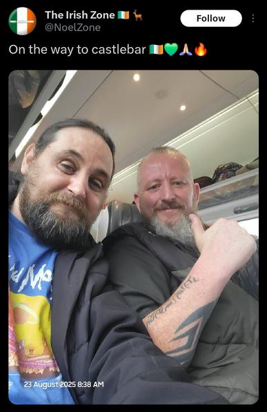 Tweet from TheIrishZone on Twitter. A selfie of two idiots on a train, captioned On the way to Castlebar - followed by four emojis: Irish flag, green heart, high five & fire.