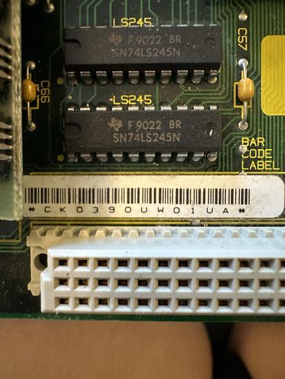 Closeup of the logicboard: large white plastic port and serial number for the board CK0390UW01UA 
Two LS245 Chips