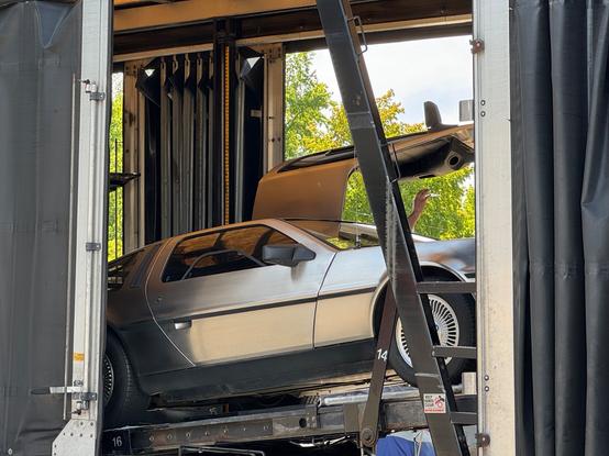 A delorean loaded up in a shipping transport