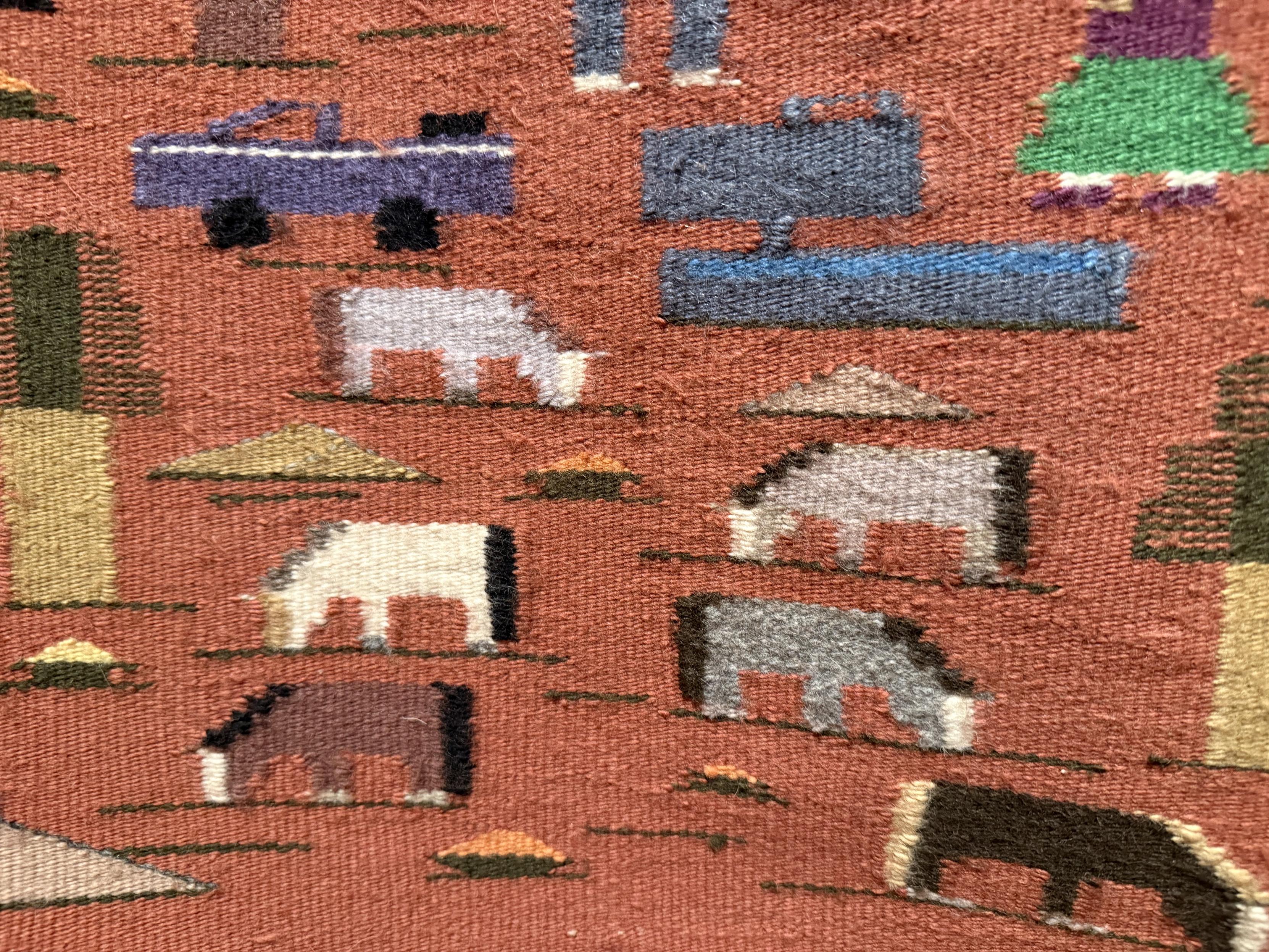 Detail from the pictorial weaving showing a couple of trees, a truck, and several horses or donkeys grazing. All are rendered in minimal detail.