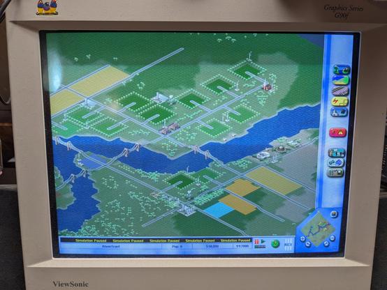 SimCity 3000 Unlimited being played on the same monitor. A new game has just been started using the Riverfront starter map.