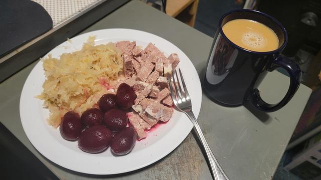 Cold plate breakfast of Corned Beef, Beetroot, and Sauerkraut.,with a hot mug of Coffee.