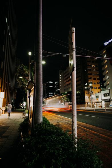 photo of a street by night with some light beams indicating a long time exposure