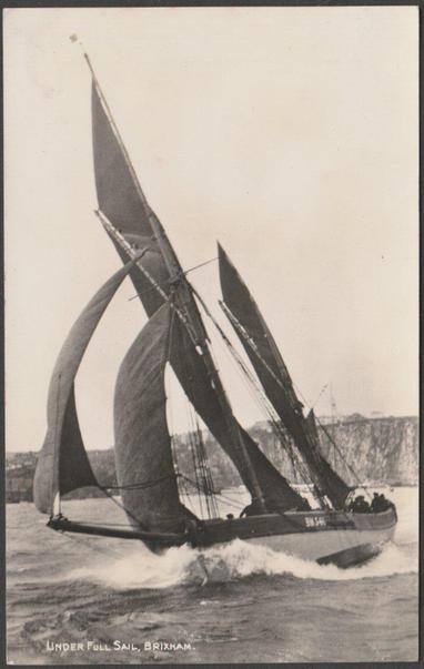 Monochrome real photographic postcard showing a yacht under full sail at Brixham in Devon.

Publisher not stated, not numbered, c.1930.

Postally unused.

Good condition, with very slight corner bumps, but some marks to the back.